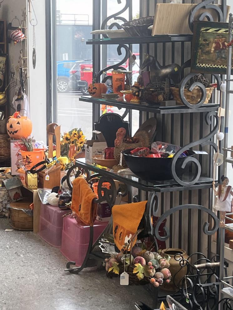 Woman looking at items at front of Used a Bit Store
