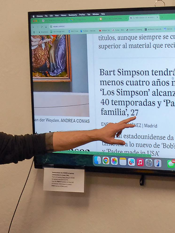 Spanish teacher leads class discussion of headlines.
