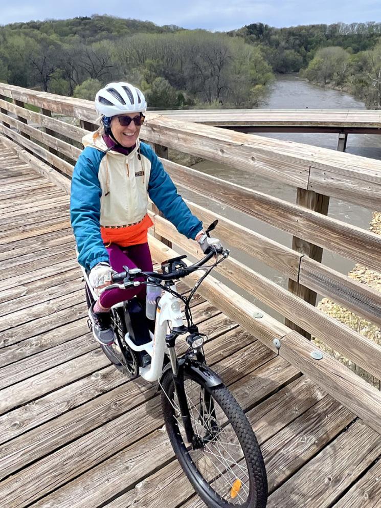 Pedalers crossing a bridge