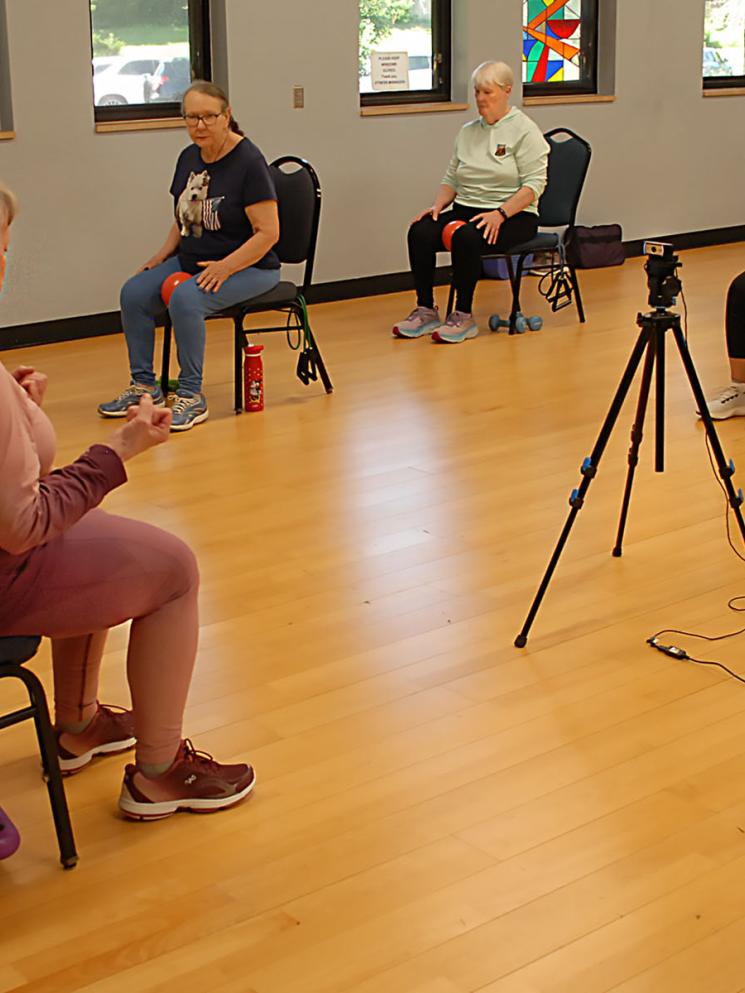 Sheila leading a Silver Sneakers exercise group, in person and online