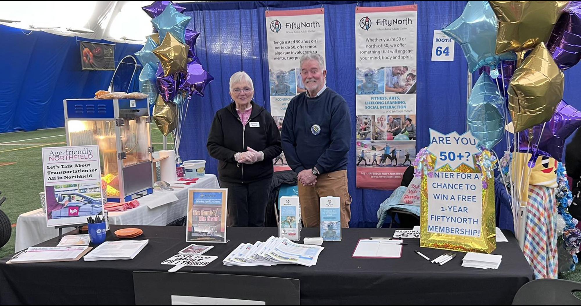 A woman and a man at a FiftyNorth information booth